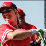 Olivia Barbas (13) of Newark East Side laughs in the dugout during the baseball game Newark East Side and Payne Tech at Riverbank Park in Newark, NJ on Monday, May 15, 2023.