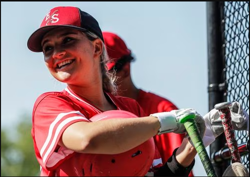 Olivia Barbas (13) of Newark East Side laughs in the dugout during the baseball game Newark East Side and Payne Tech at Riverbank Park in Newark, NJ on Monday, May 15, 2023.