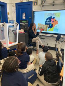 Board Member Norton reads to the children from Chancellor Avenue School