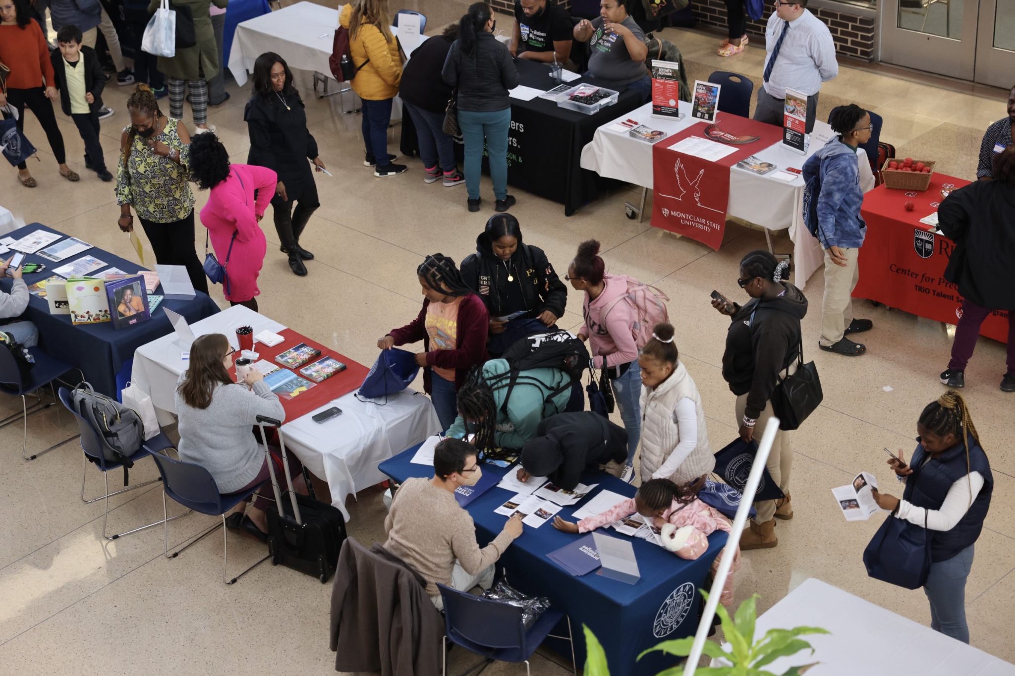 Students and families interact with program representatives at Central High School