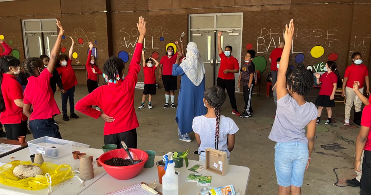 Louise A. Spencer’s Green Team engaged in an outdoor learning lab in preparation for the Schoolyard Garden