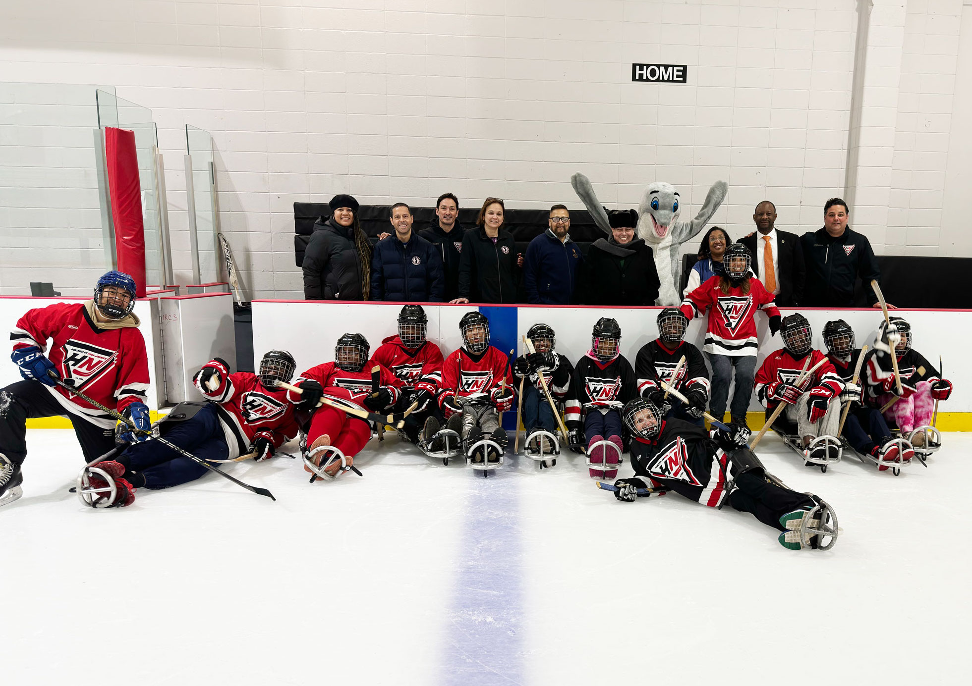 Sled Hockey Teams from John F. Kennedy and New Jersey Regional Day pose for a team photo with Superintendent León